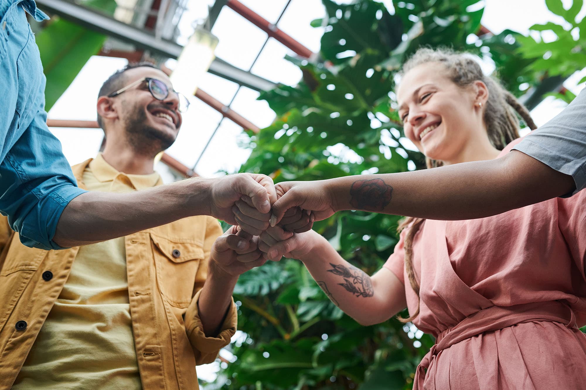 A group of people fist-bumping and smiling